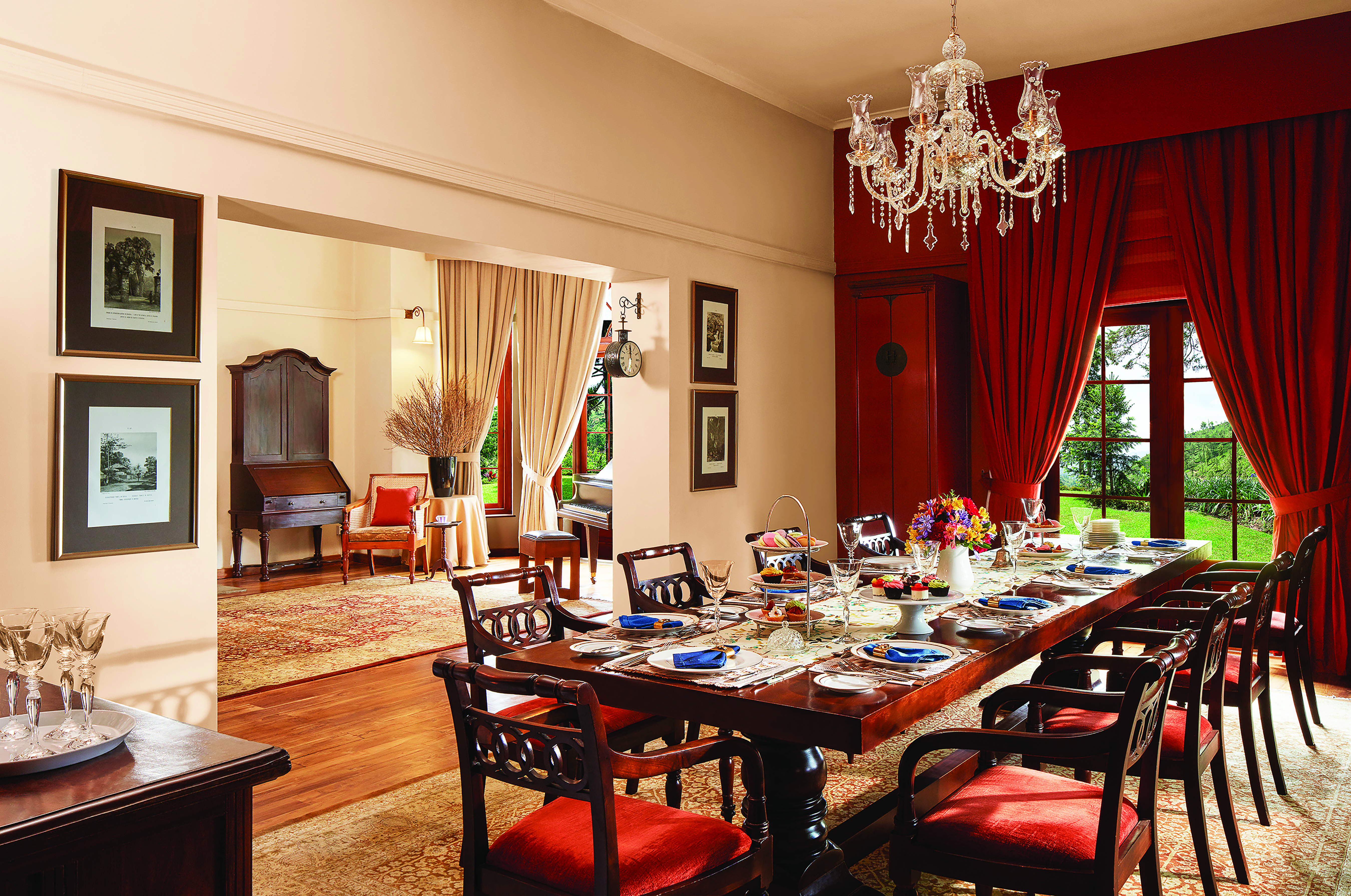 Jetwing Warwick Gardens dining room, table set for dinner, draped curtains, chandelier, grand decor