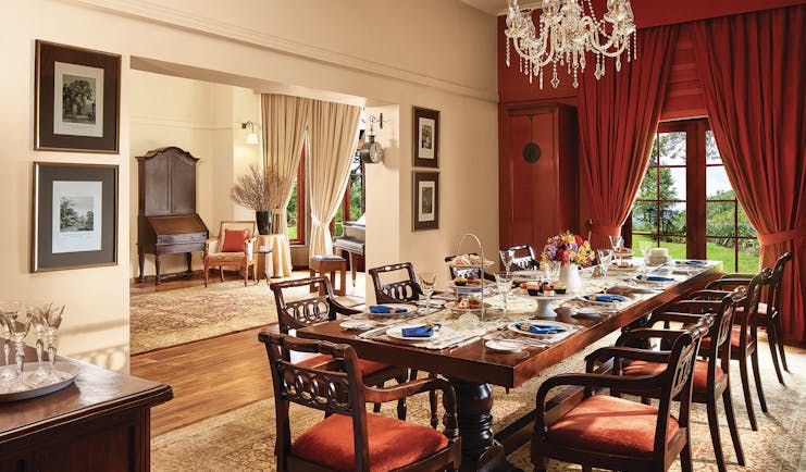 Jetwing Warwick Gardens dining room, table set for dinner, draped curtains, chandelier, grand decor