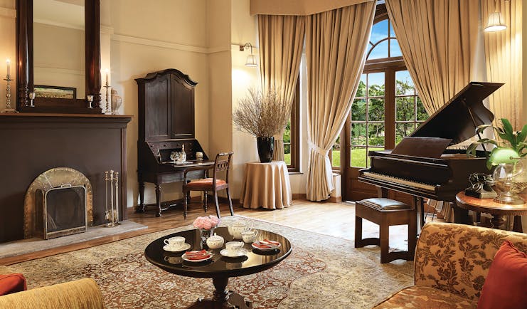 Jetwing Warwick Gardens living room, piano, antique furniture, elegant decor