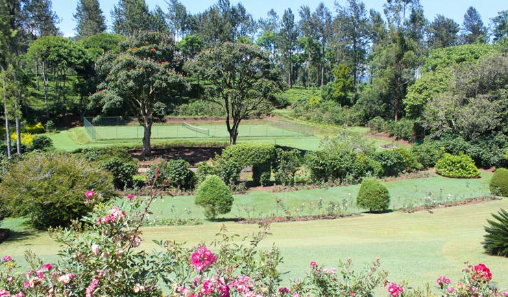 Kirchhayn Bungalow Sri Lanka tennis court from across lawned gardens