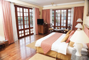 Mahaweli Reach Hotel deluxe room, double bed, modern decor
