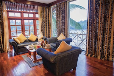 Mahaweli Reach Hotel executive suite, sofas, armchairs, view of river