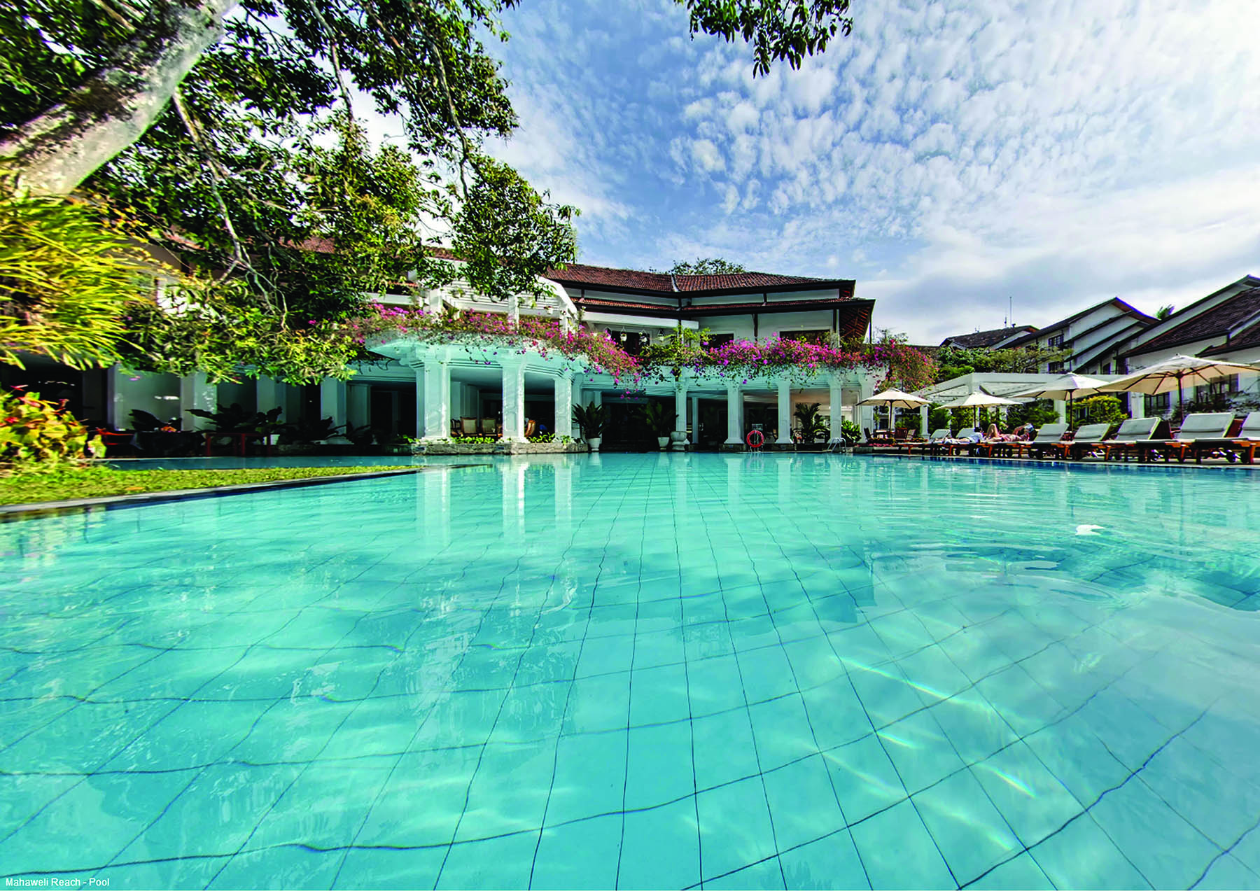 Mahaweli Reach Hotel pool, sun loungers, umbrellas