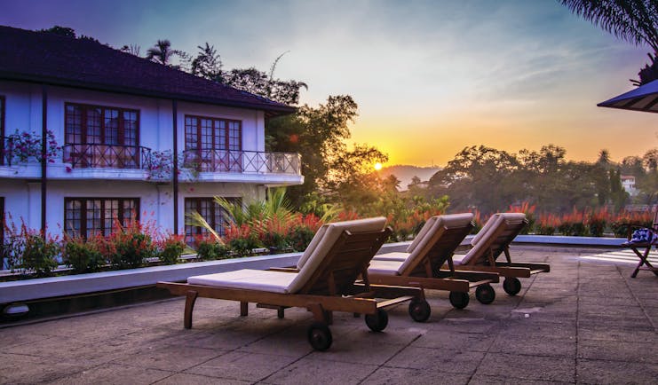 Mahaweli Reach Hotel poolside, sun loungers