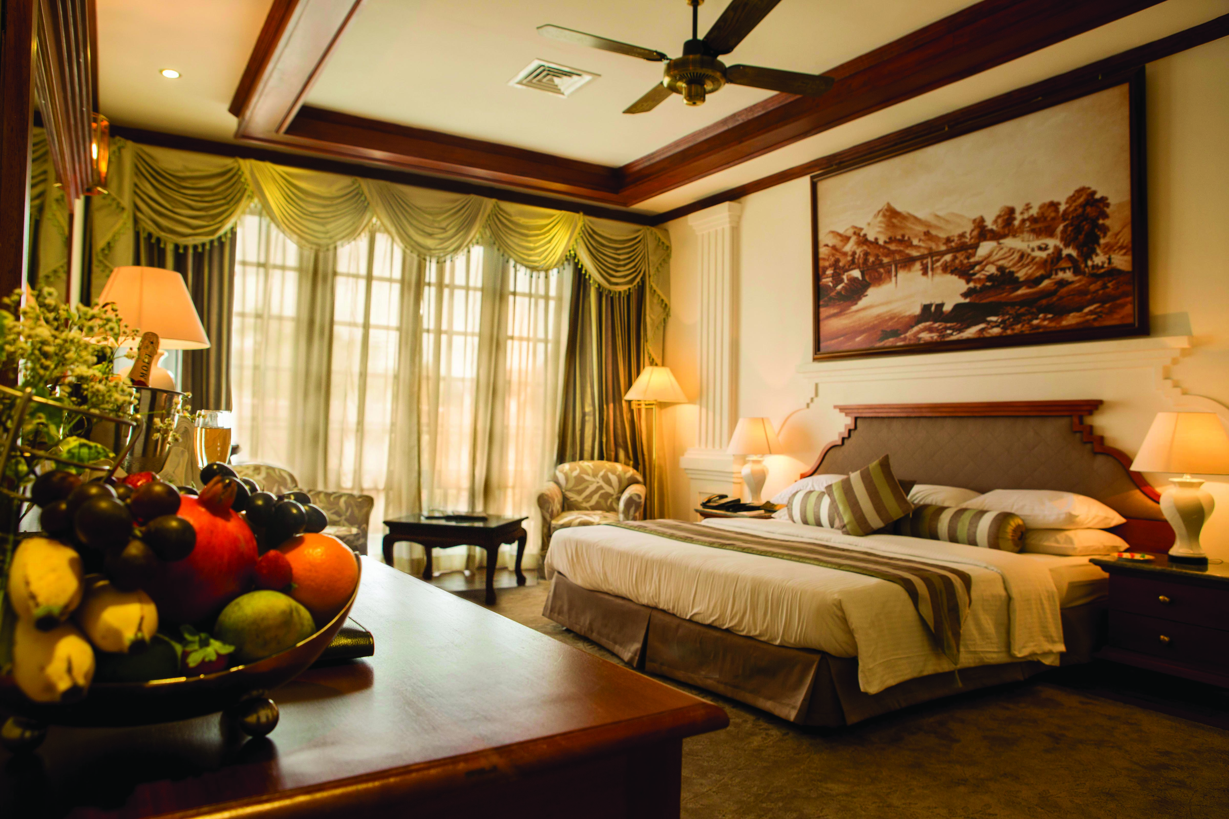 Mahaweli Reach Hotel presidential suite, double bed, traditional decor