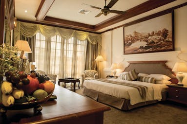 Mahaweli Reach Hotel presidential suite, double bed, traditional decor