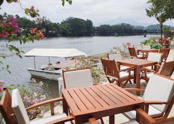 Mahaweli Reach Hotel terrace, tables and chairs overlooking river