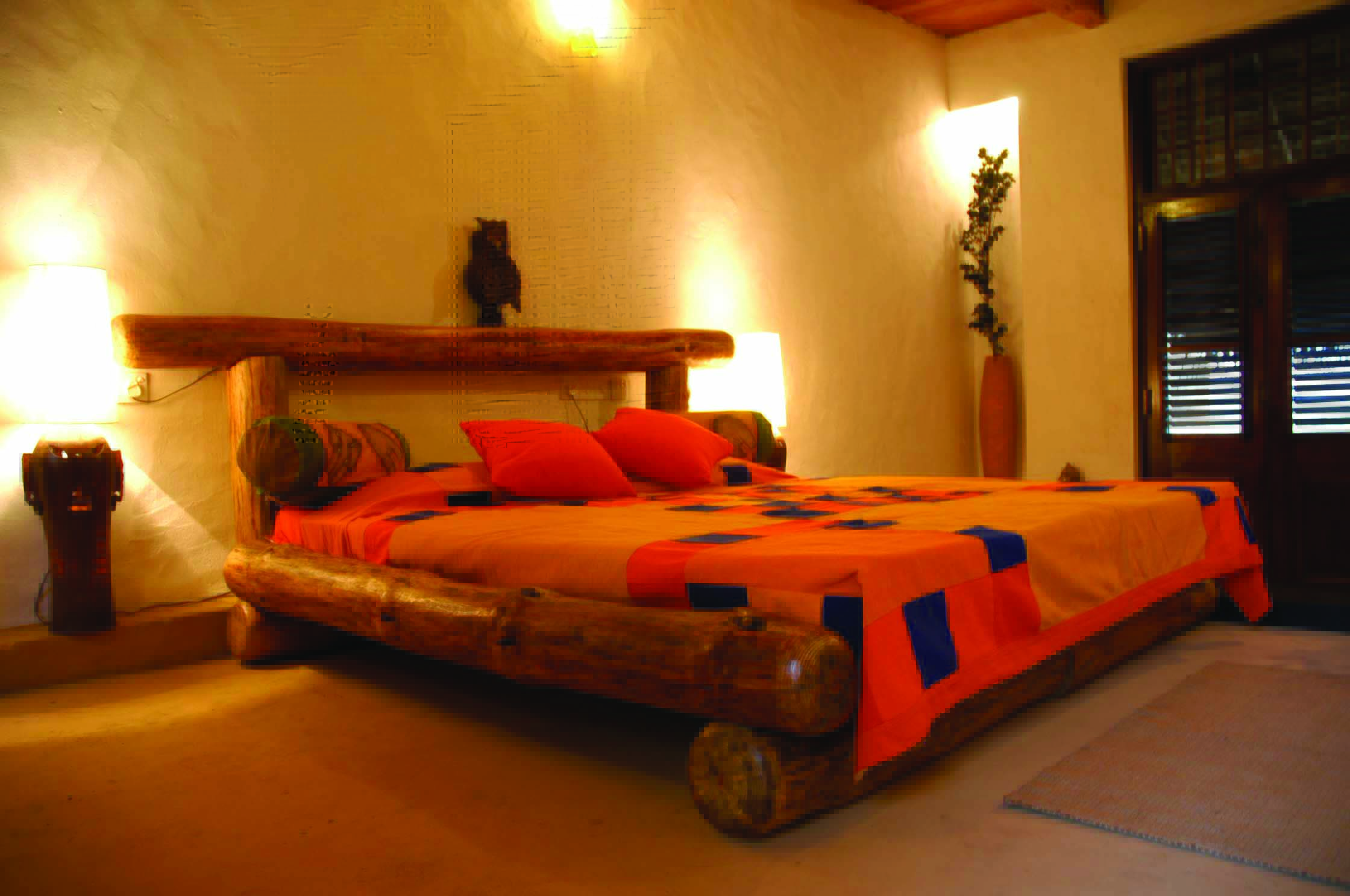 Rainforest Edge bedroom, double bed with tree trunk frame, bright simple decor