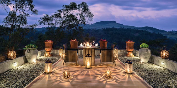 Taylor's Hill Sri Lanka terrace outdoor dining by night mountains in background