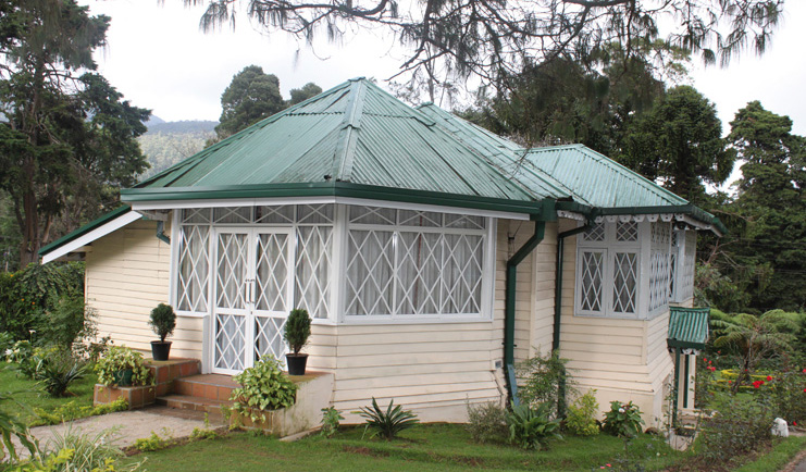 The Hill Club Sri Lanka bungalow exterior white building green roof