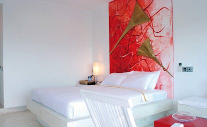 Theva Expressions Sri Lanka bedroom artwork white bed and red painting with trumpets
