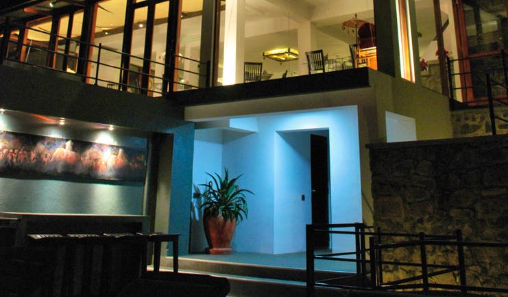 Theva Expressions Sri Lanka outdoor view artwork and large windows to hotel at night