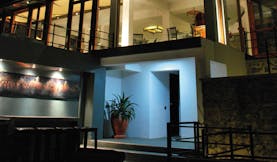Theva Expressions Sri Lanka outdoor view artwork and large windows to hotel at night