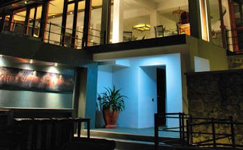 Theva Expressions Sri Lanka outdoor view artwork and large windows to hotel at night