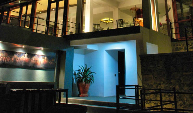 Theva Expressions Sri Lanka outdoor view artwork and large windows to hotel at night