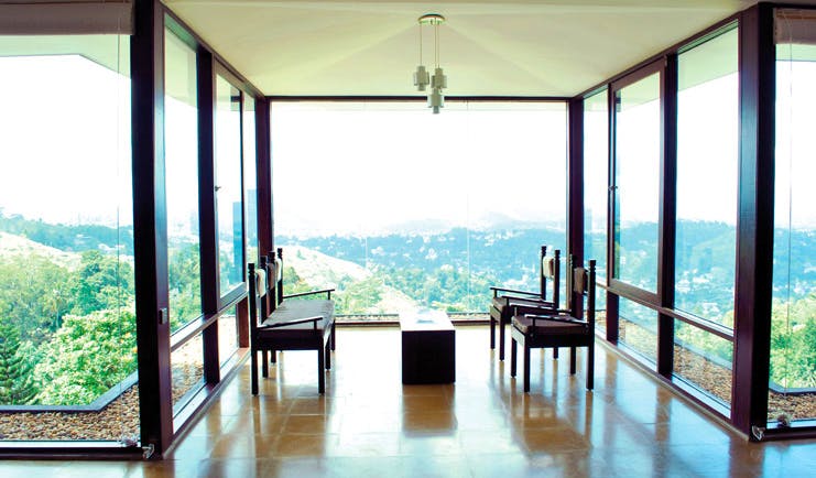 Theva Expressions Sri Lanka seats in lobby with panoramic forest views