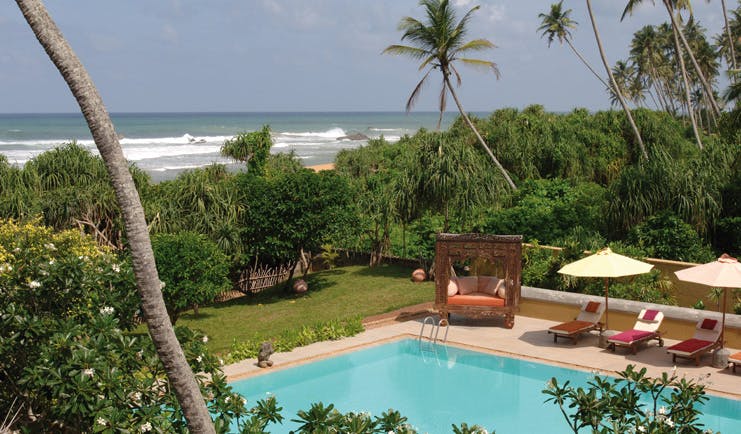 Aditya Resort outdoor pool with loungers cabana garden and sea view 