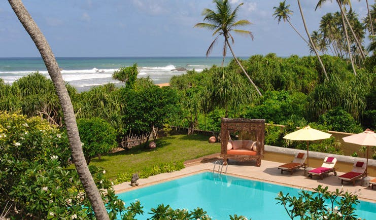 Aditya Resort outdoor pool with loungers cabana garden and sea view 
