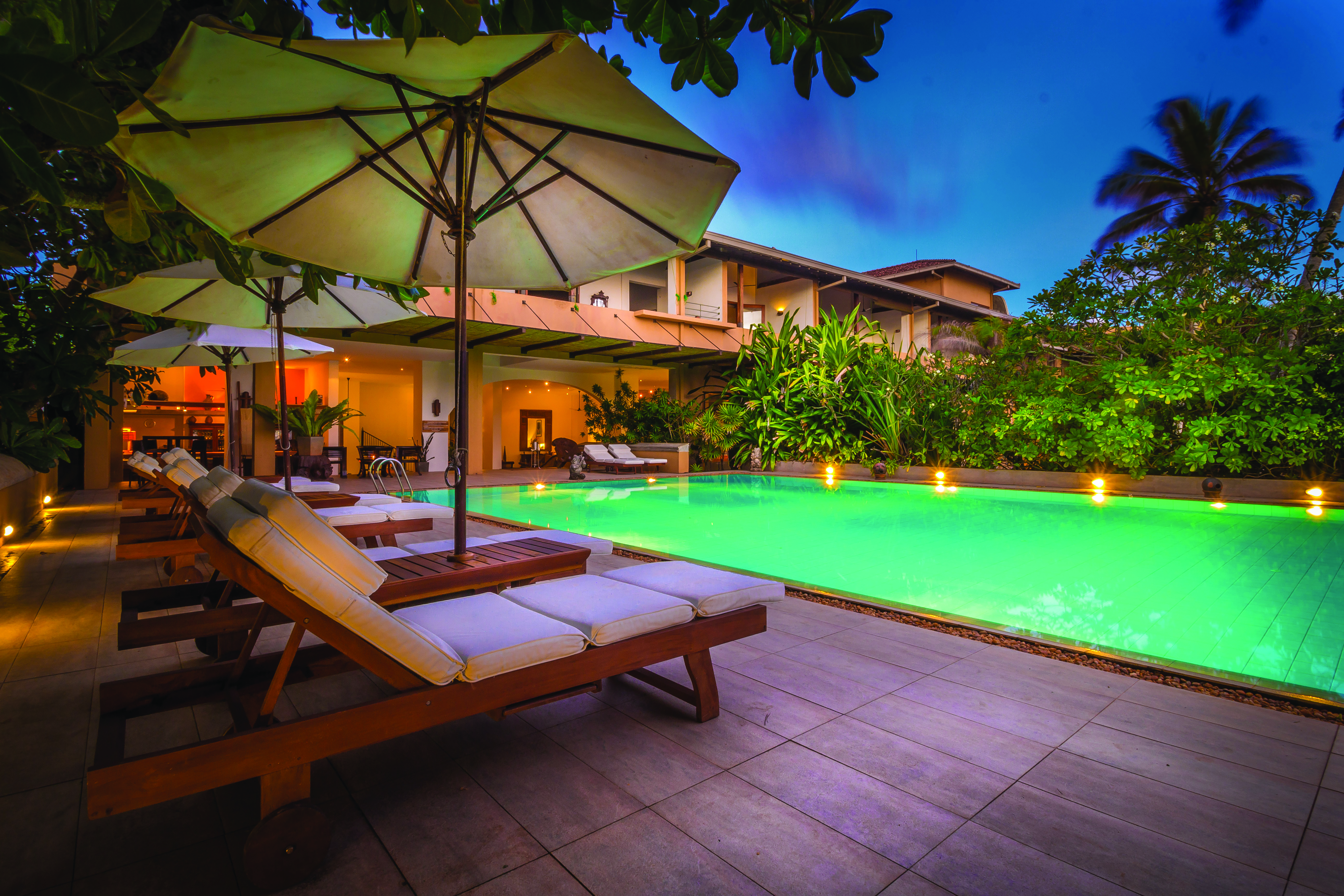 Aditya Resort poolside. sun loungers, umbrellas