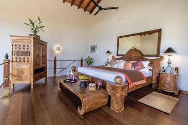 Aditya Resort surya suite, double bed with wooden frame, antique furniture, elegant decor