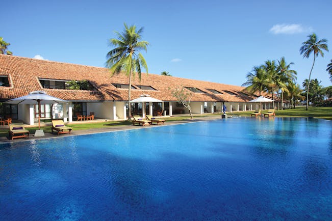 Avani Bentota Sri Lanka pool sun loungers umbrellas palm trees