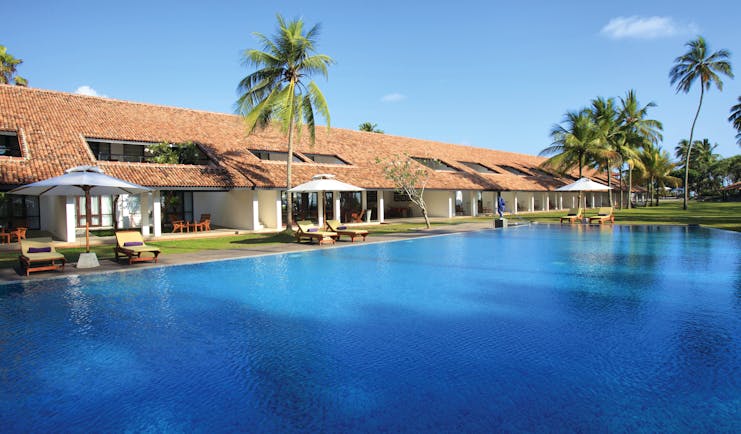 Avani Bentota Sri Lanka pool sun loungers umbrellas palm trees