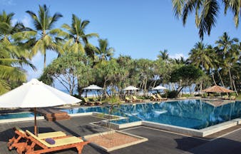 Avani Bentota Sri Lanka poolside sun loungers umbrellas beach in background