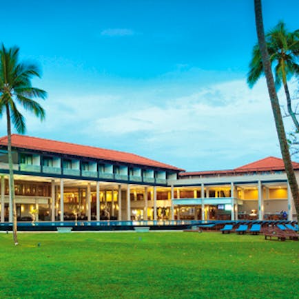 Cinnamon Bey exterior with palm trees shown on lawn in front of hotel