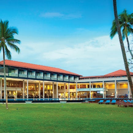 Cinnamon Bey exterior with palm trees shown on lawn in front of hotel