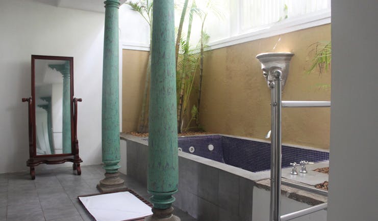 Club Villa Sri Lanka bathroom with columns freestanding mirror and blue tiled bath