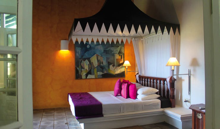 Club Villa Sri Lanka deluxe bedroom with canopy and tiled floors