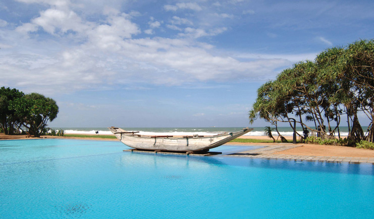 Outdoor pool with old traditional boat floating on it 