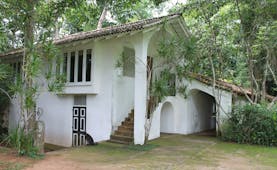 Lunuganga Sri Lanka gate house exterior white building with archways and trees