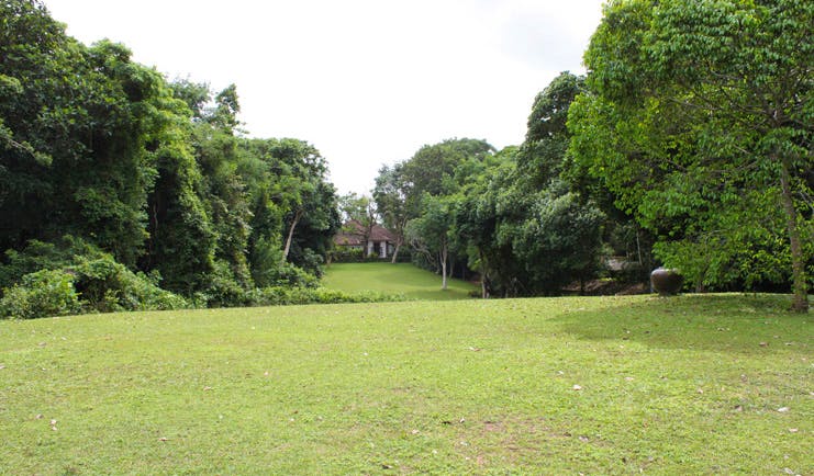 Lunuganga Sri Lanka house exterior lawn view of white building