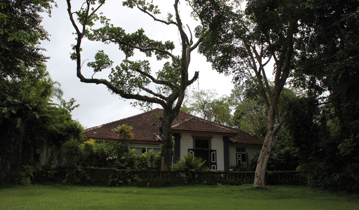 Lunuganga Sri Lanka main house exterior white bungalow and gardens