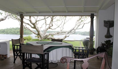 Lunuganga Sri Lanka terrace seating overlooking tree garden and lake