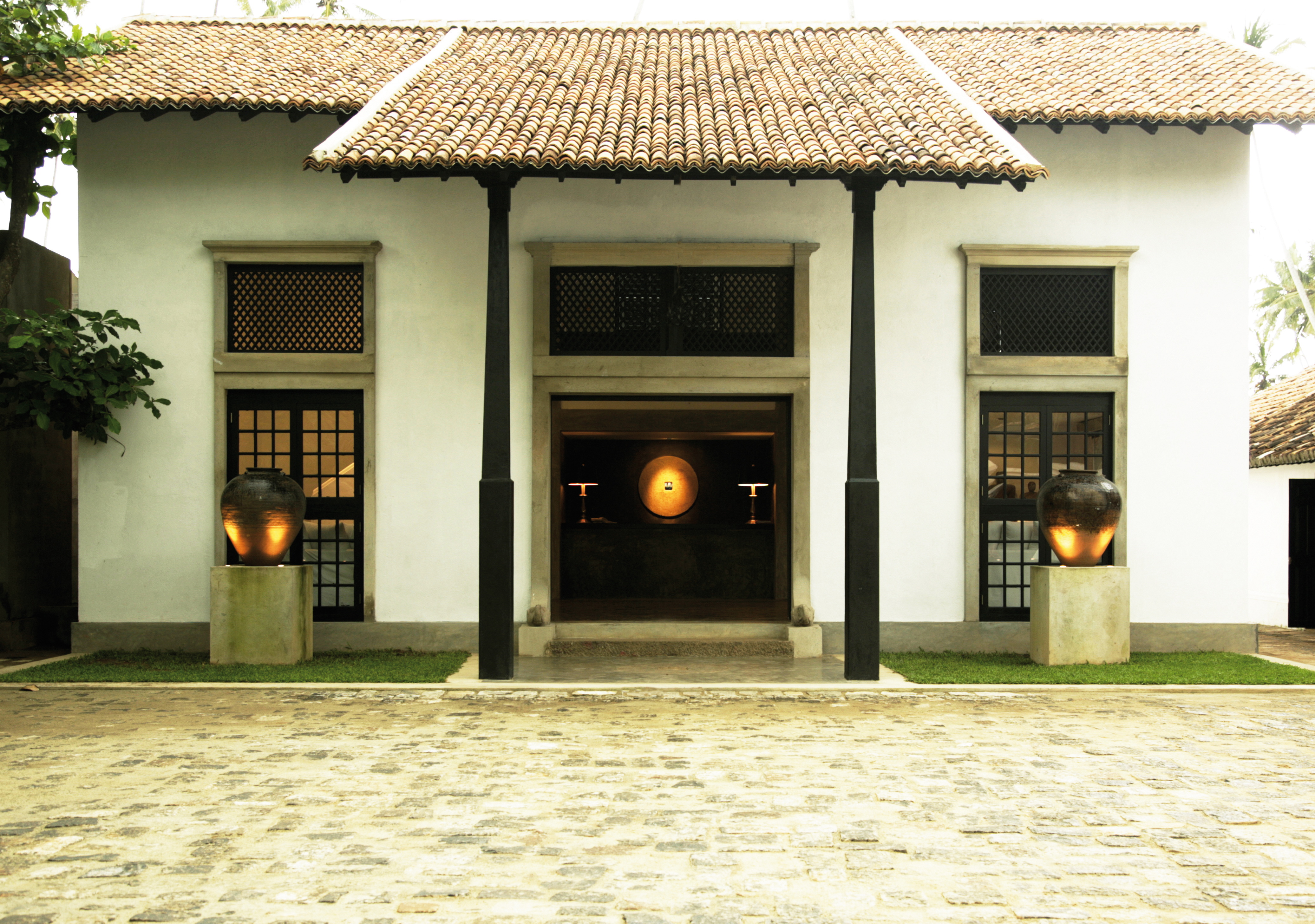 Entrance to the hotel with beach hut style toof and lanterns 