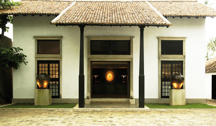 Paradise Road The Villa Bentota Sri Lanka entrance white building with gold urns