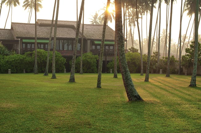 Reef Villa and Spa grounds, lawns, trees, hotel building in background