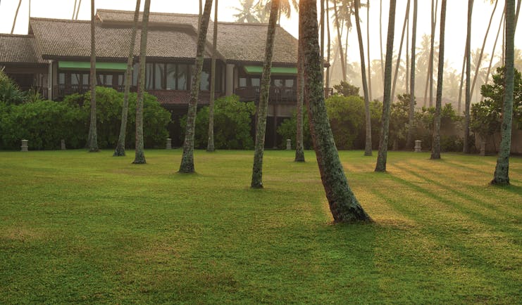 Reef Villa and Spa grounds, lawns, trees, hotel building in background