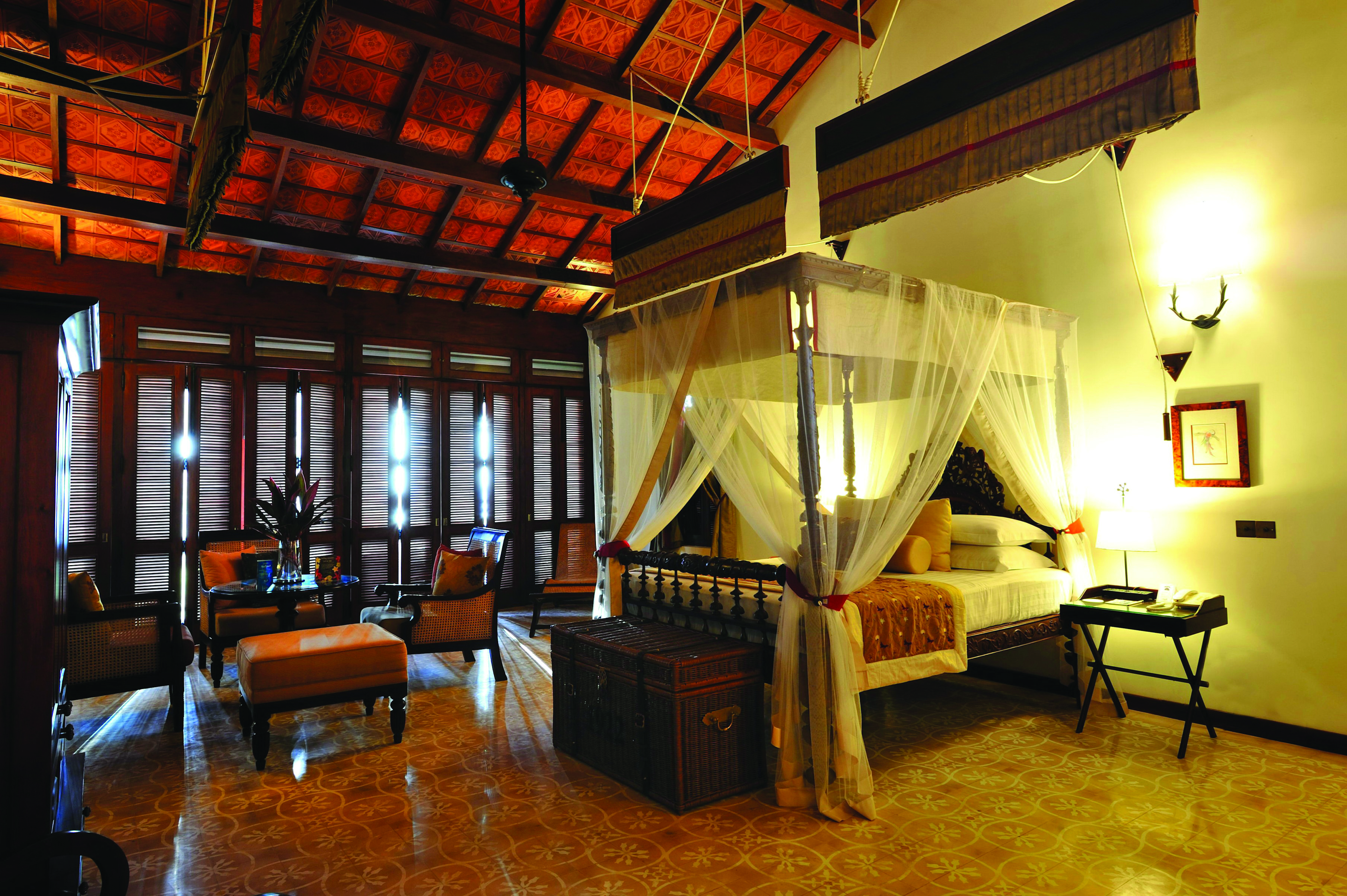 Reef Villa and Spa main house suite, canopied bed, antique furniture, elegant decor