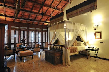 Reef Villa and Spa main house suite, canopied bed, antique furniture, elegant decor