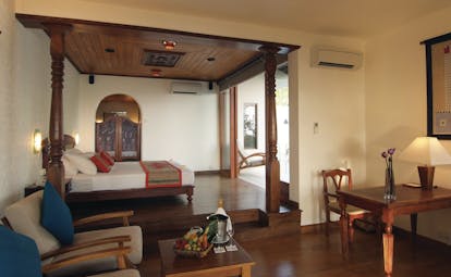 Saman Villas Sri Lanka grand deluxe suite bed lounge area elegant traditional décor