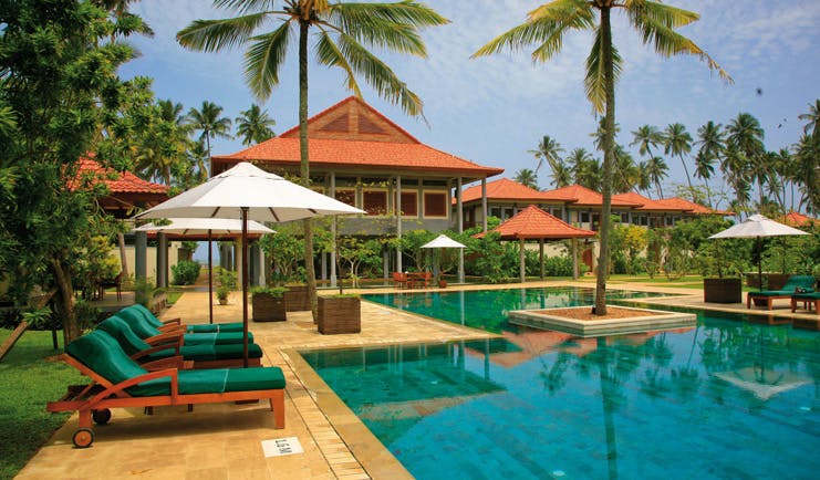 Serene Pavilions Sri Lanka pool sun loungers umbrellas palm trees