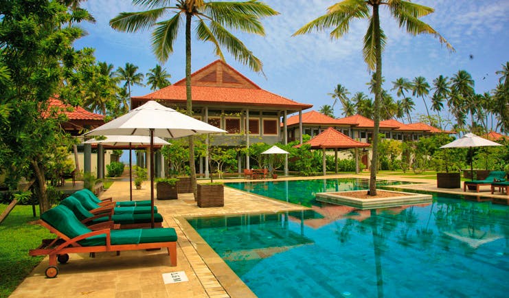 Serene Pavilions Sri Lanka pool sun loungers umbrellas palm trees