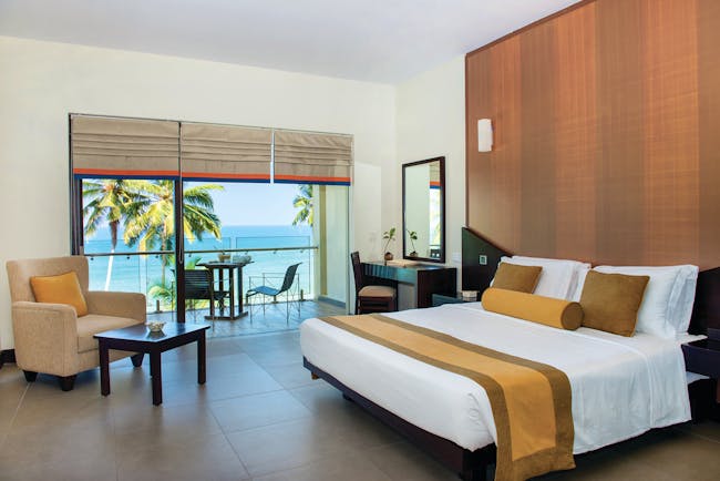 Shinagawa Beach Sri Lanka deluxe room bed armchair modern décor private terrace