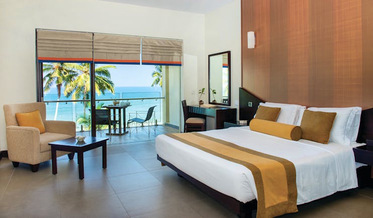 Shinagawa Beach Sri Lanka deluxe room bed armchair modern décor private terrace