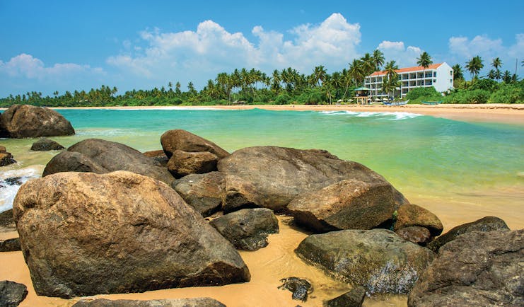 Shinagawa Beach Sri Lanka exterior beach palm trees hotel building in background