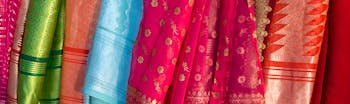 Silk material in shades of red and pink hanging up in Sri Lanka