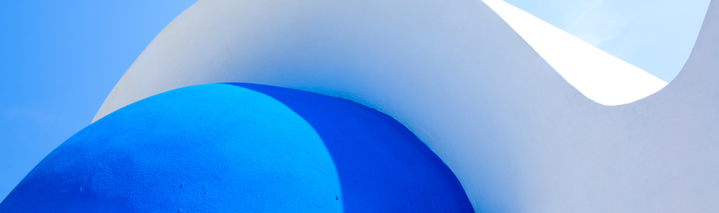 Bright blue dome and white roof of a Greek church